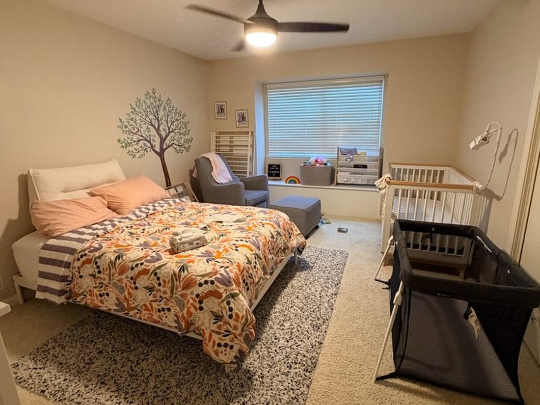 Bedroom with queen bed, crib, and pack-and-play together